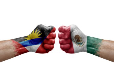 Two hands punch to each others on white background. Country flags painted fists, conflict crisis concept between antigua and barbuda and mexico