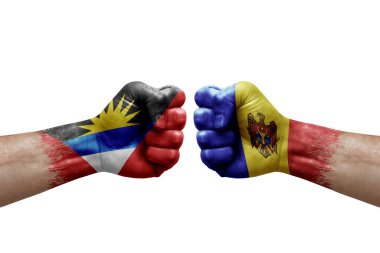Two hands punch to each others on white background. Country flags painted fists, conflict crisis concept between antigua and barbuda and moldova