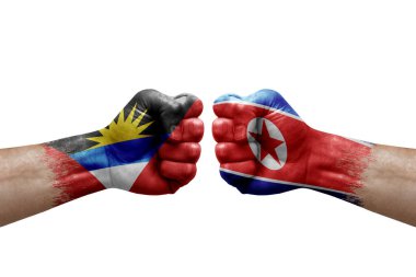Two hands punch to each others on white background. Country flags painted fists, conflict crisis concept between antigua and barbuda and north korea