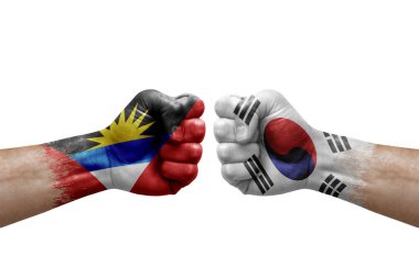 Two hands punch to each others on white background. Country flags painted fists, conflict crisis concept between antigua and barbuda and south korea