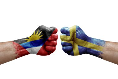 Two hands punch to each others on white background. Country flags painted fists, conflict crisis concept between antigua and barbuda and sweden
