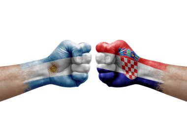 Two hands punch to each others on white background. Country flags painted fists, conflict crisis concept between argentina and croatia