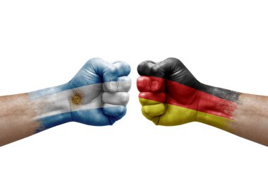 Two hands punch to each others on white background. Country flags painted fists, conflict crisis concept between argentina and germany