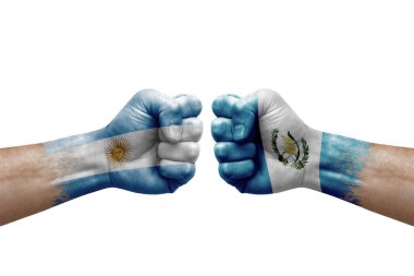 Two hands punch to each others on white background. Country flags painted fists, conflict crisis concept between argentina and guatemala