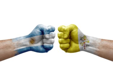 Two hands punch to each others on white background. Country flags painted fists, conflict crisis concept between argentina and holy see