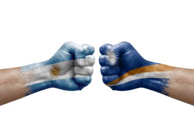 Two hands punch to each others on white background. Country flags painted fists, conflict crisis concept between argentina and marshall islands