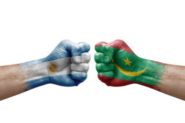 Two hands punch to each others on white background. Country flags painted fists, conflict crisis concept between argentina and mauritania