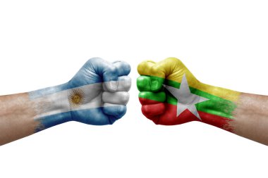 Two hands punch to each others on white background. Country flags painted fists, conflict crisis concept between argentina and myanmar