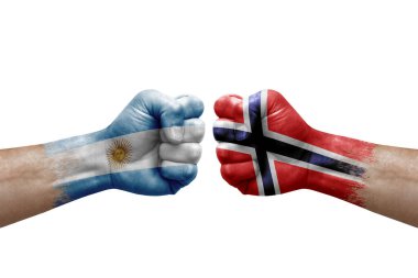Two hands punch to each others on white background. Country flags painted fists, conflict crisis concept between argentina and norway