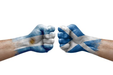 Two hands punch to each others on white background. Country flags painted fists, conflict crisis concept between argentina and scotland