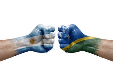 Two hands punch to each others on white background. Country flags painted fists, conflict crisis concept between argentina and solomon islands