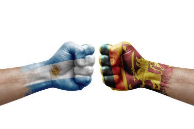 Two hands punch to each others on white background. Country flags painted fists, conflict crisis concept between argentina and sri lanka