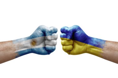 Two hands punch to each others on white background. Country flags painted fists, conflict crisis concept between argentina and ukraine
