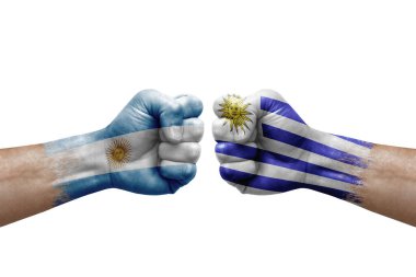 Two hands punch to each others on white background. Country flags painted fists, conflict crisis concept between argentina and uruguay