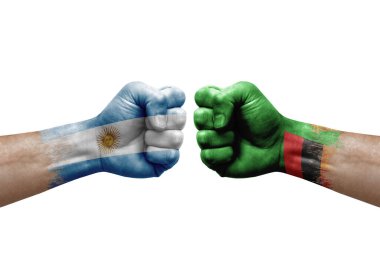 Two hands punch to each others on white background. Country flags painted fists, conflict crisis concept between argentina and zambia