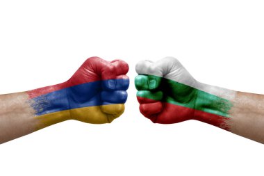 Two hands punch to each others on white background. Country flags painted fists, conflict crisis concept between armenia and bulgaria