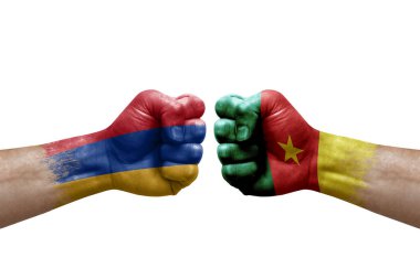 Two hands punch to each others on white background. Country flags painted fists, conflict crisis concept between armenia and cameroon