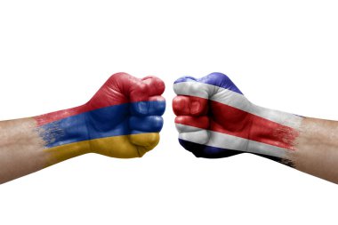 Two hands punch to each others on white background. Country flags painted fists, conflict crisis concept between armenia and costa rica