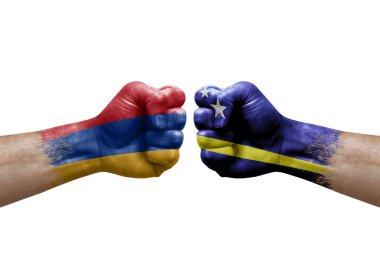 Two hands punch to each others on white background. Country flags painted fists, conflict crisis concept between armenia and curacao