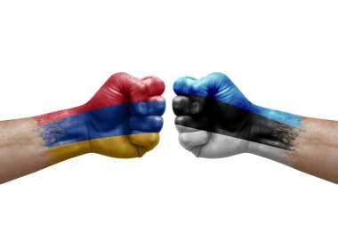 Two hands punch to each others on white background. Country flags painted fists, conflict crisis concept between armenia and estonia