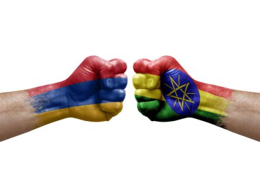 Two hands punch to each others on white background. Country flags painted fists, conflict crisis concept between armenia and ethiopia