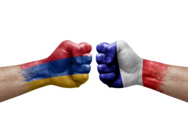 Two hands punch to each others on white background. Country flags painted fists, conflict crisis concept between armenia and france