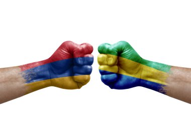 Two hands punch to each others on white background. Country flags painted fists, conflict crisis concept between armenia and gabon