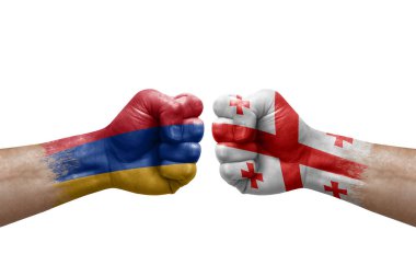 Two hands punch to each others on white background. Country flags painted fists, conflict crisis concept between armenia and georgia