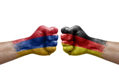 Two hands punch to each others on white background. Country flags painted fists, conflict crisis concept between armenia and germany
