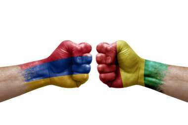 Two hands punch to each others on white background. Country flags painted fists, conflict crisis concept between armenia and guinea