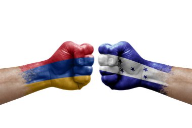 Two hands punch to each others on white background. Country flags painted fists, conflict crisis concept between armenia and honduras