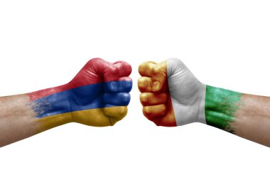 Two hands punch to each others on white background. Country flags painted fists, conflict crisis concept between armenia and ivory coast