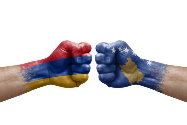 Two hands punch to each others on white background. Country flags painted fists, conflict crisis concept between armenia and kosovo