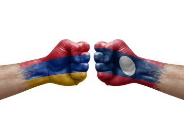 Two hands punch to each others on white background. Country flags painted fists, conflict crisis concept between armenia and laos