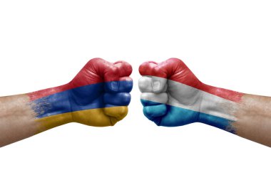 Two hands punch to each others on white background. Country flags painted fists, conflict crisis concept between armenia and luxembourg