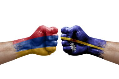 Two hands punch to each others on white background. Country flags painted fists, conflict crisis concept between armenia and nauru