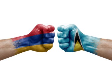 Two hands punch to each others on white background. Country flags painted fists, conflict crisis concept between armenia and saint lucia
