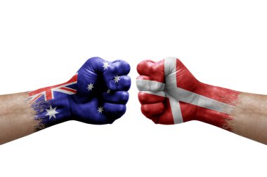 Two hands punch to each others on white background. Country flags painted fists, conflict crisis concept between australia and denmark