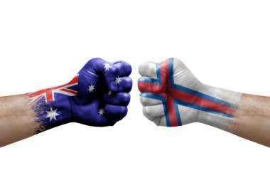 Two hands punch to each others on white background. Country flags painted fists, conflict crisis concept between australia and faroe islands