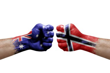 Two hands punch to each others on white background. Country flags painted fists, conflict crisis concept between australia and norway