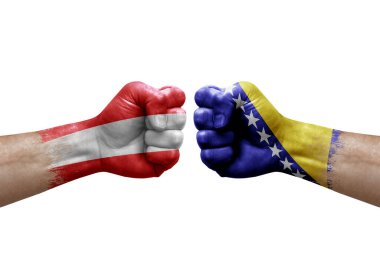 Two hands punch to each others on white background. Country flags painted fists, conflict crisis concept between austria and bosnia