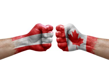 Two hands punch to each others on white background. Country flags painted fists, conflict crisis concept between austria and canada