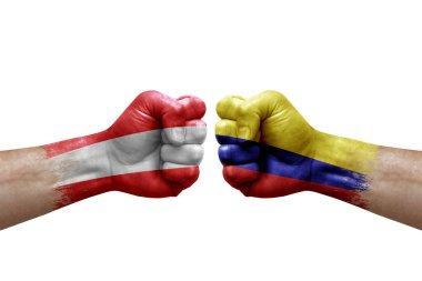 Two hands punch to each others on white background. Country flags painted fists, conflict crisis concept between austria and colombia