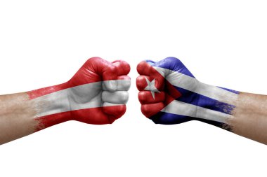 Two hands punch to each others on white background. Country flags painted fists, conflict crisis concept between austria and cuba