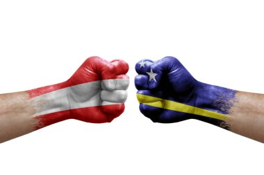 Two hands punch to each others on white background. Country flags painted fists, conflict crisis concept between austria and curacao