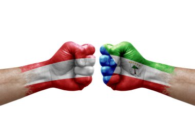 Two hands punch to each others on white background. Country flags painted fists, conflict crisis concept between austria and equatorial guinea