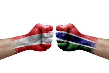 Two hands punch to each others on white background. Country flags painted fists, conflict crisis concept between austria and gambia
