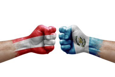 Two hands punch to each others on white background. Country flags painted fists, conflict crisis concept between austria and guatemala