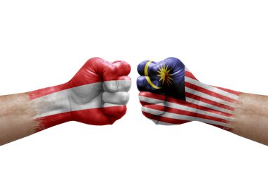 Two hands punch to each others on white background. Country flags painted fists, conflict crisis concept between austria and malaysia