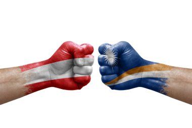 Two hands punch to each others on white background. Country flags painted fists, conflict crisis concept between austria and marshall islands
